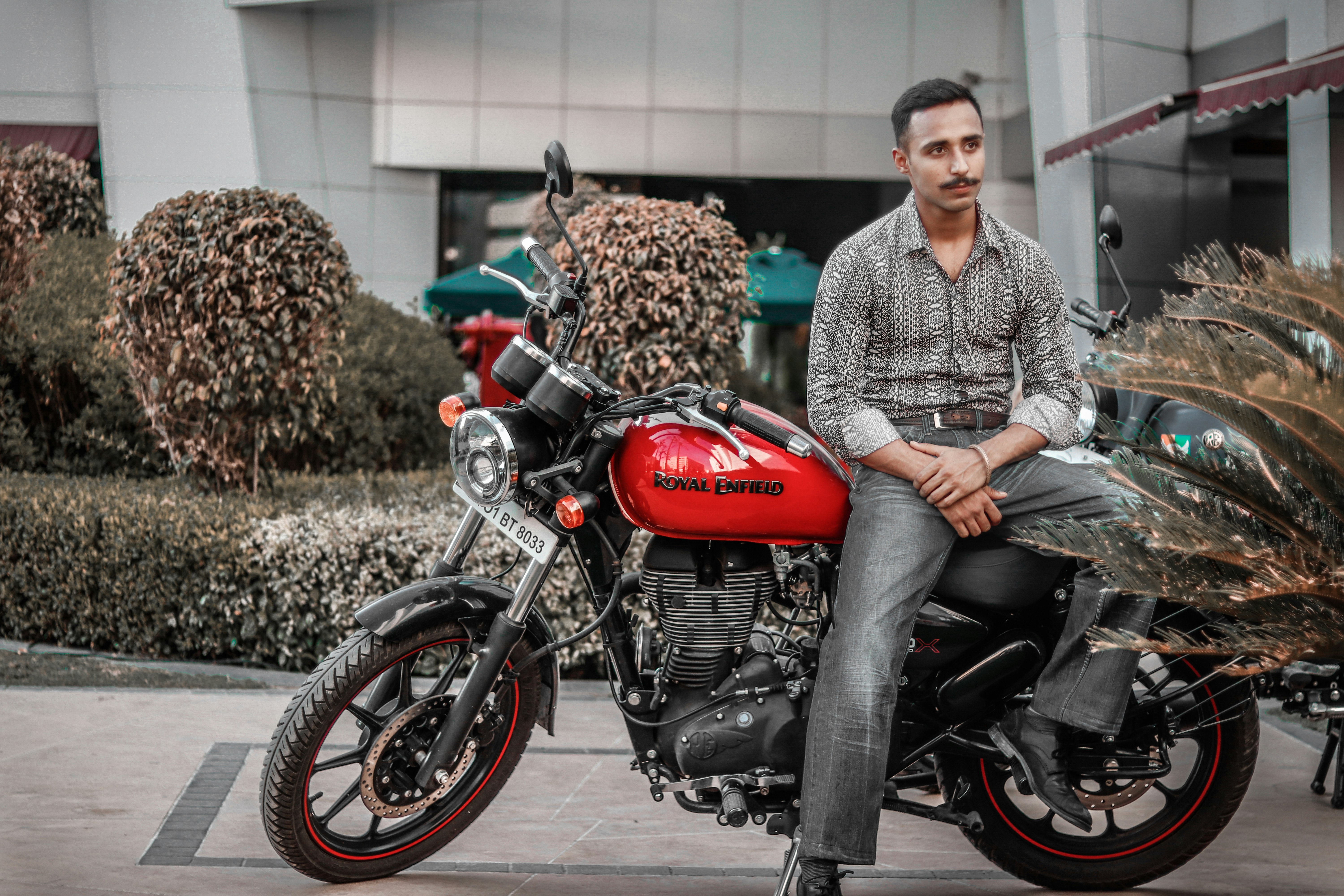 man on a red and black motorcycle